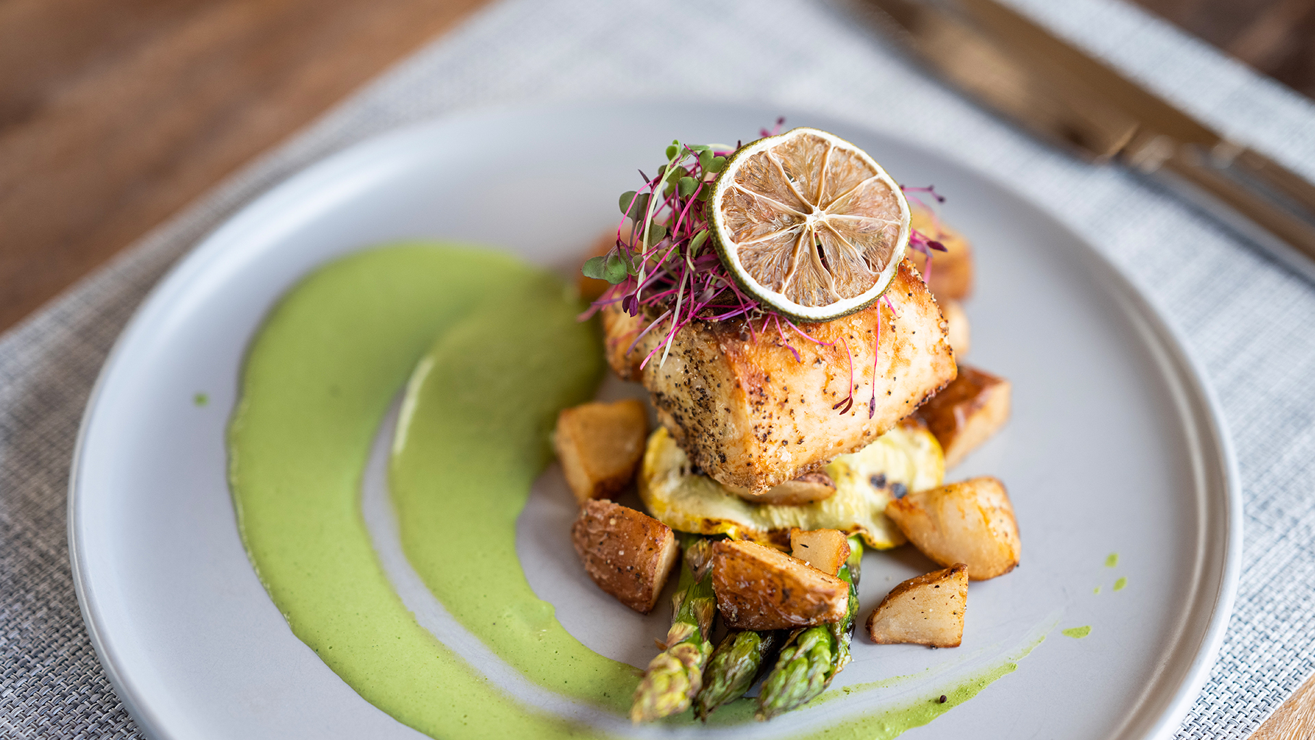 a plate of food with a lemon slice on top