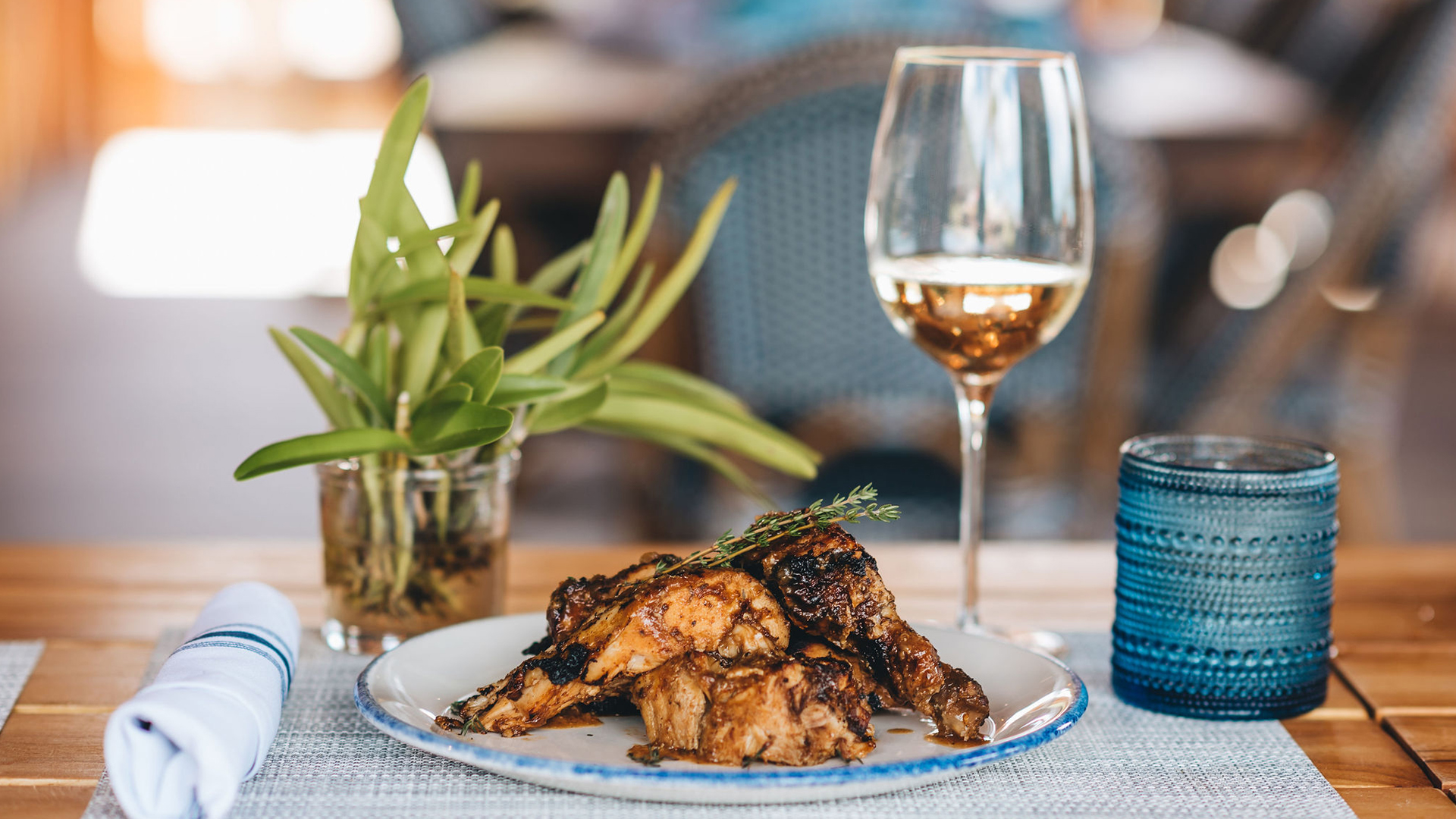 a plate of food and a glass of wine