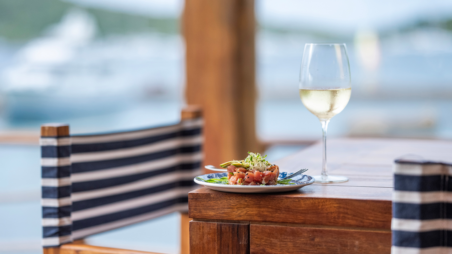 a plate of food and a glass of wine