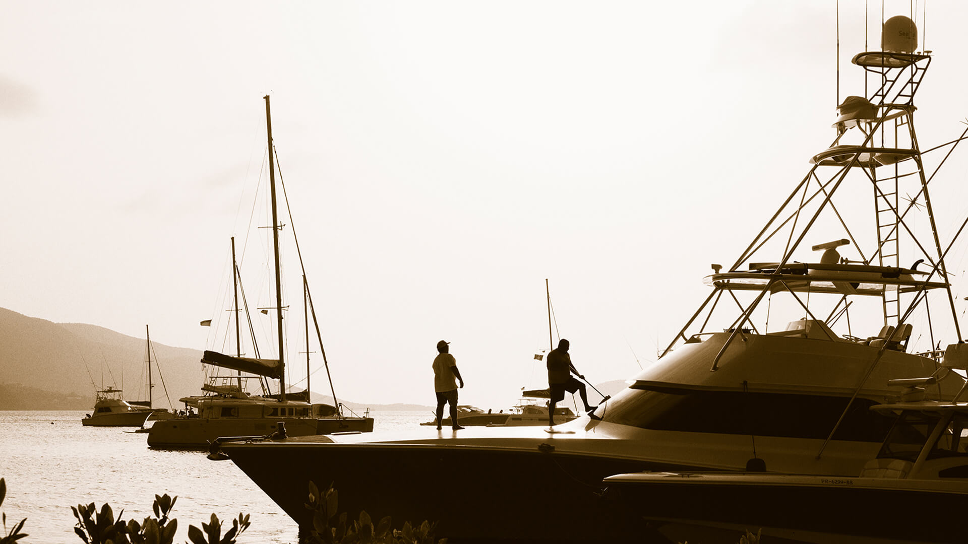 a group of people standing on a dock near boats