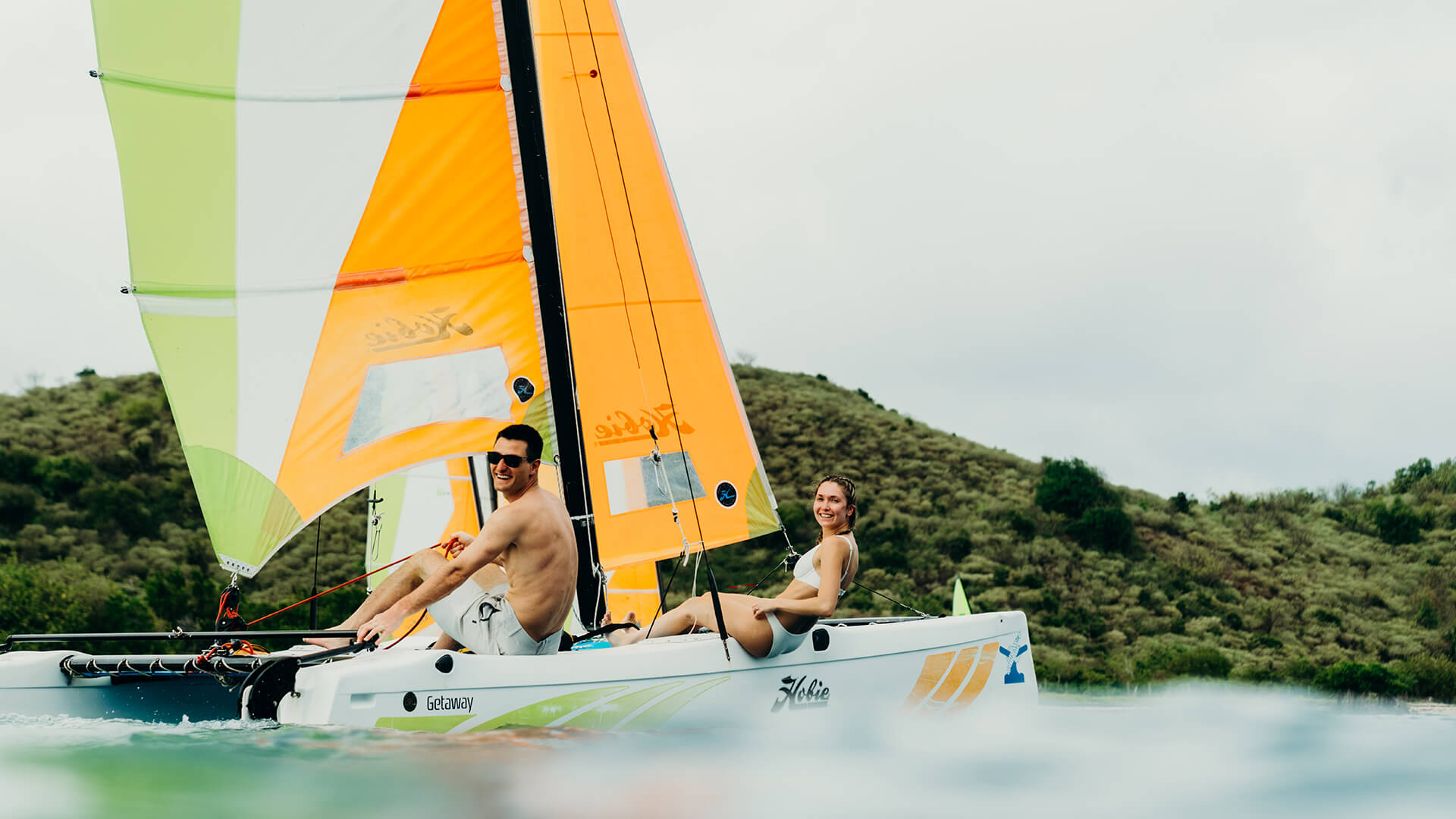 a man and woman on a sailboat
