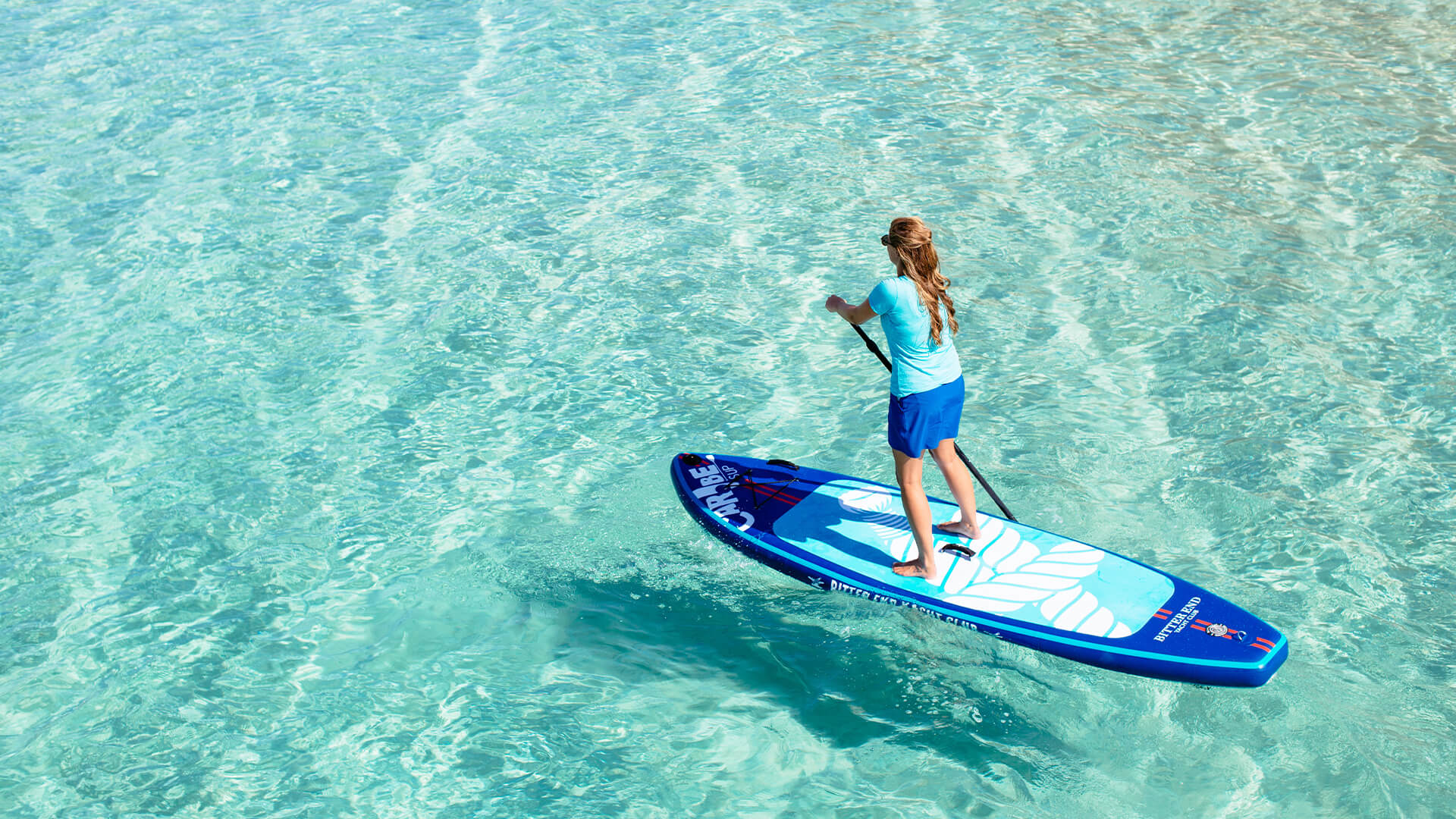 a woman on a paddle board in the water