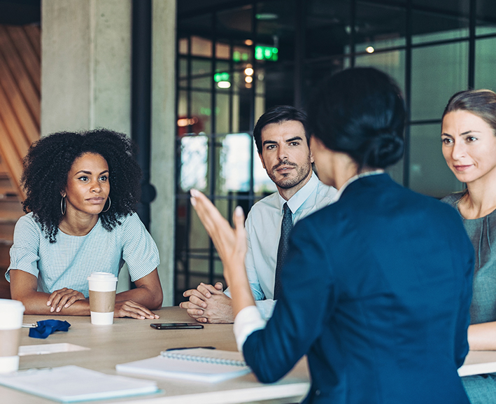 A group of colleges discussing a work issue
