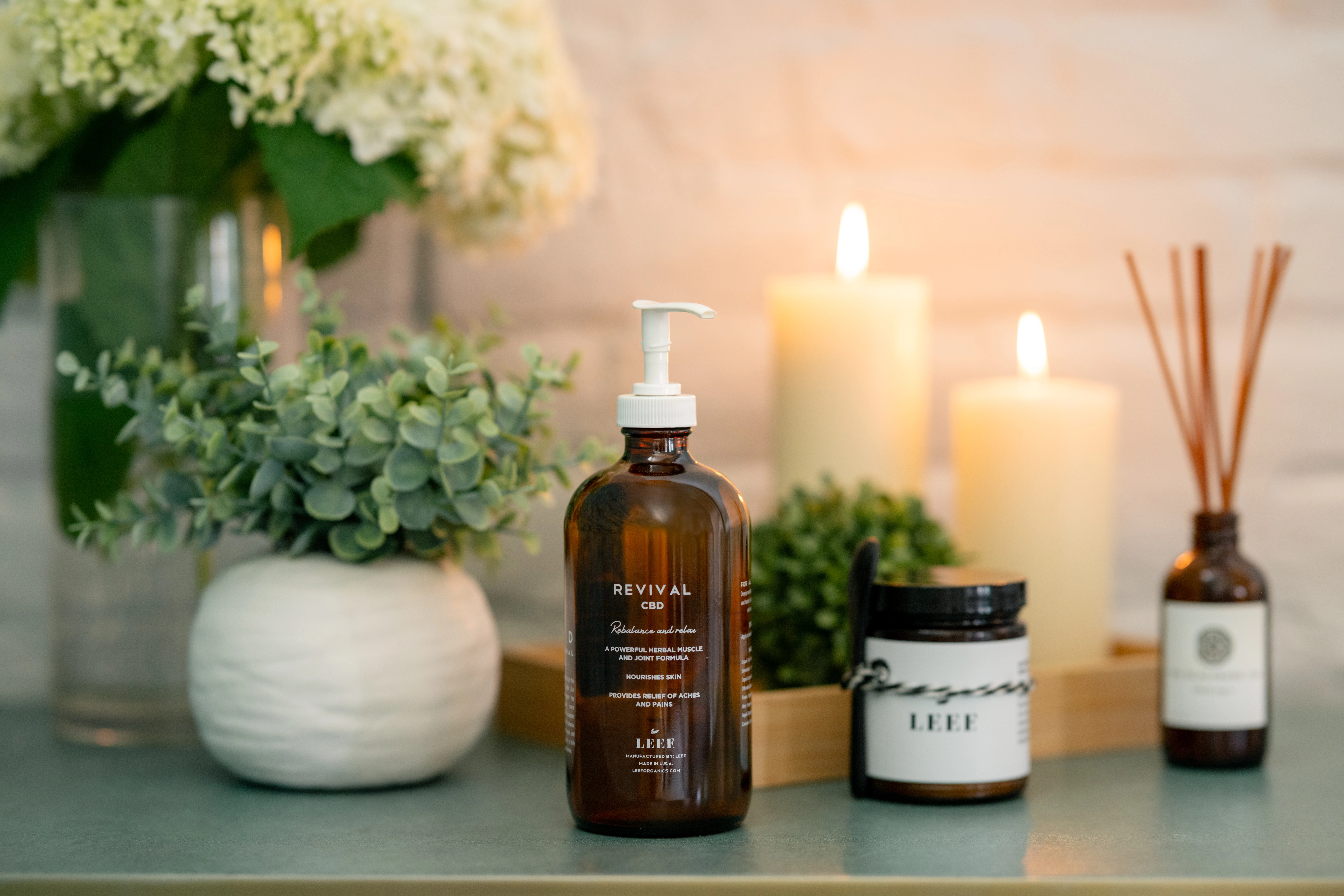 a bottle of liquid next to candles
