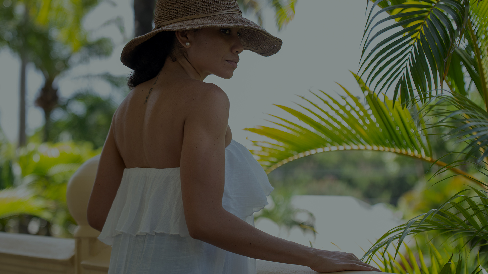 a woman wearing a hat and white dress