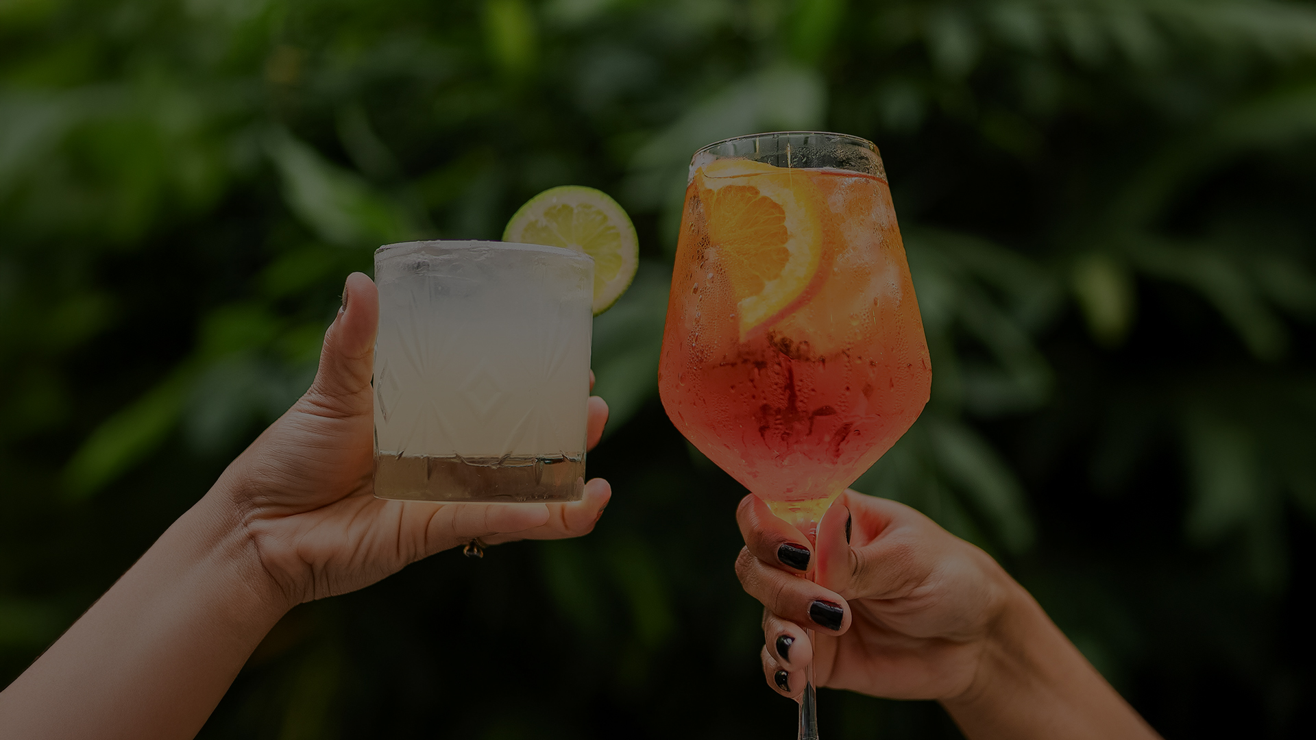 a pair of hands holding drinks