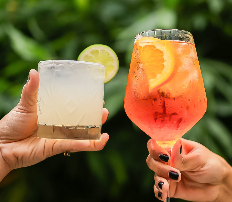 a pair of hands holding drinks