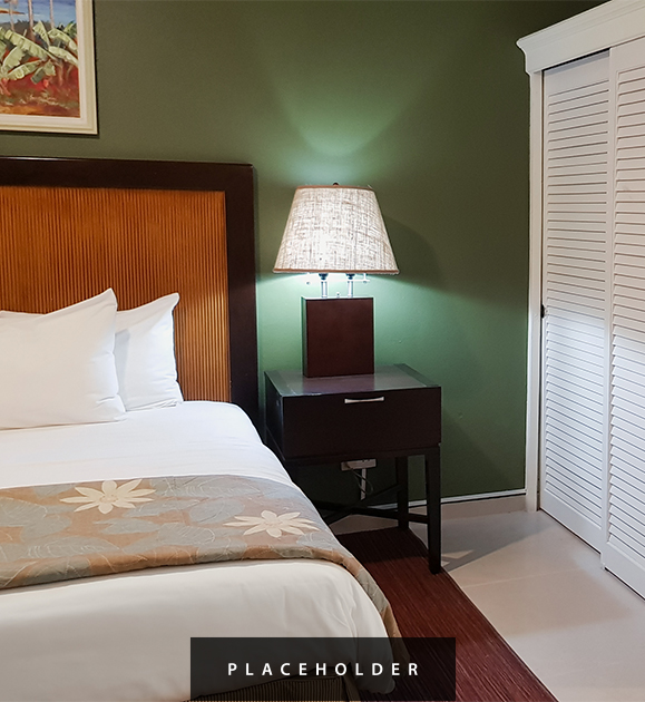 a bed with a lamp on a table