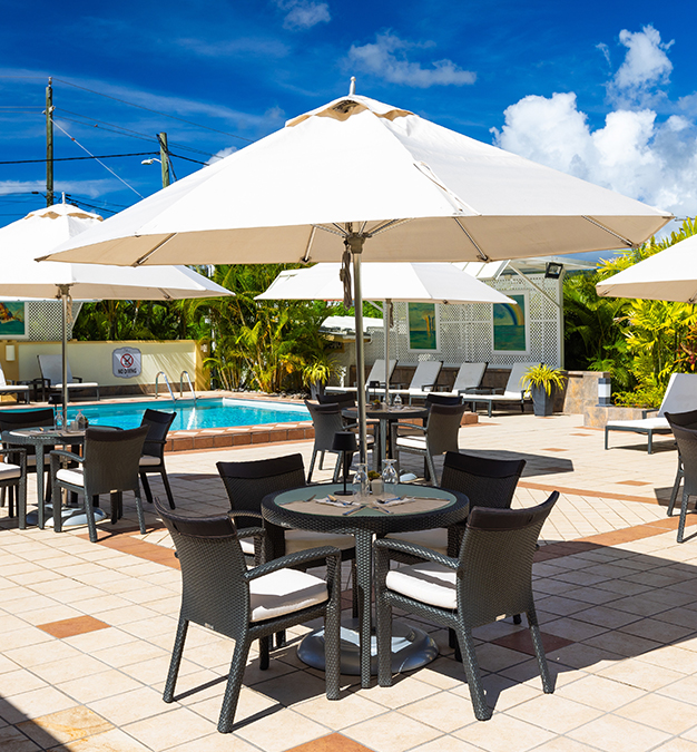 a patio with chairs and umbrellas