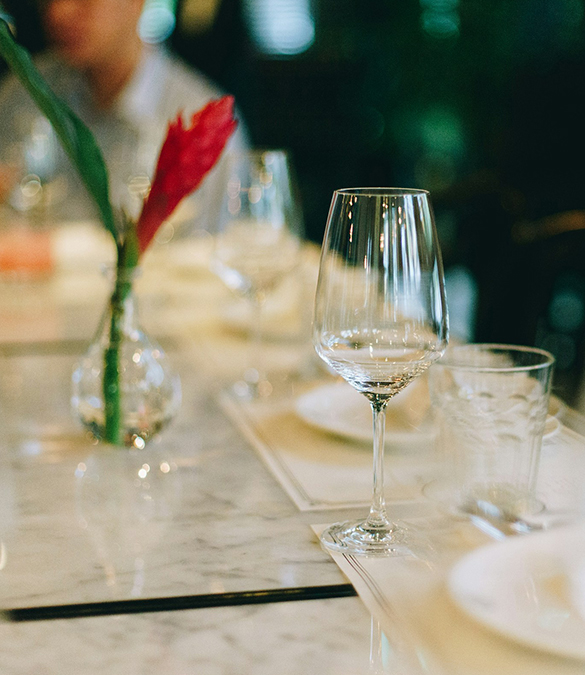 a table with glasses and a vase of flowers