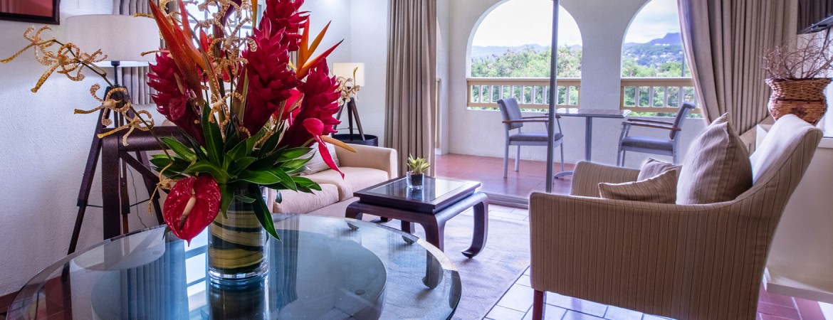 a living room with a glass table and a couch