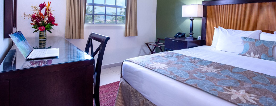 a bedroom with a desk and a lamp