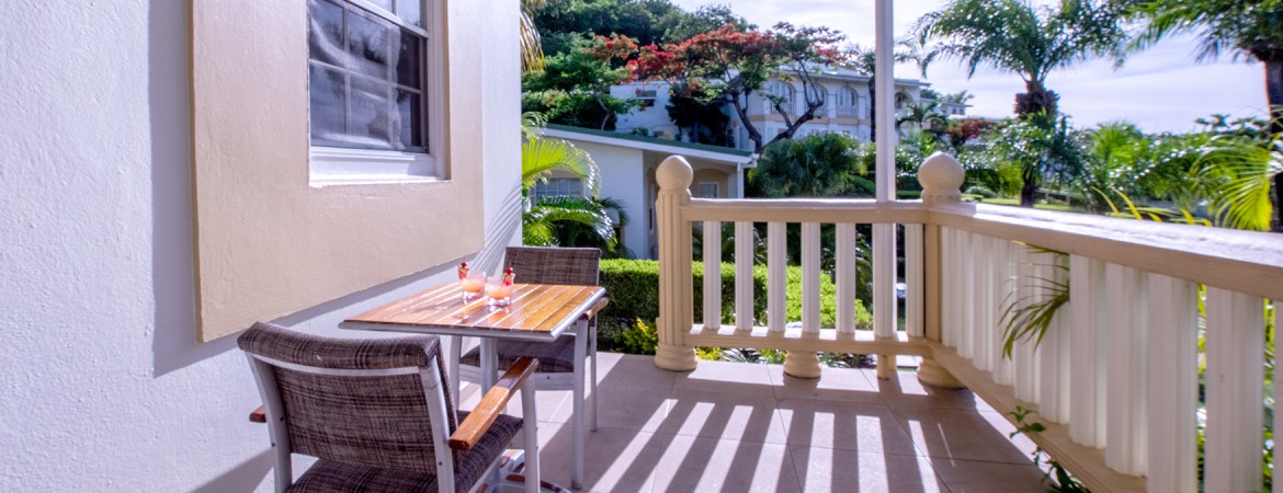 a table and chairs on a porch
