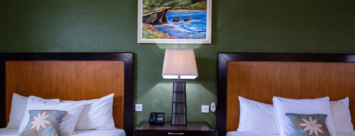 a lamp on a nightstand next to a bed