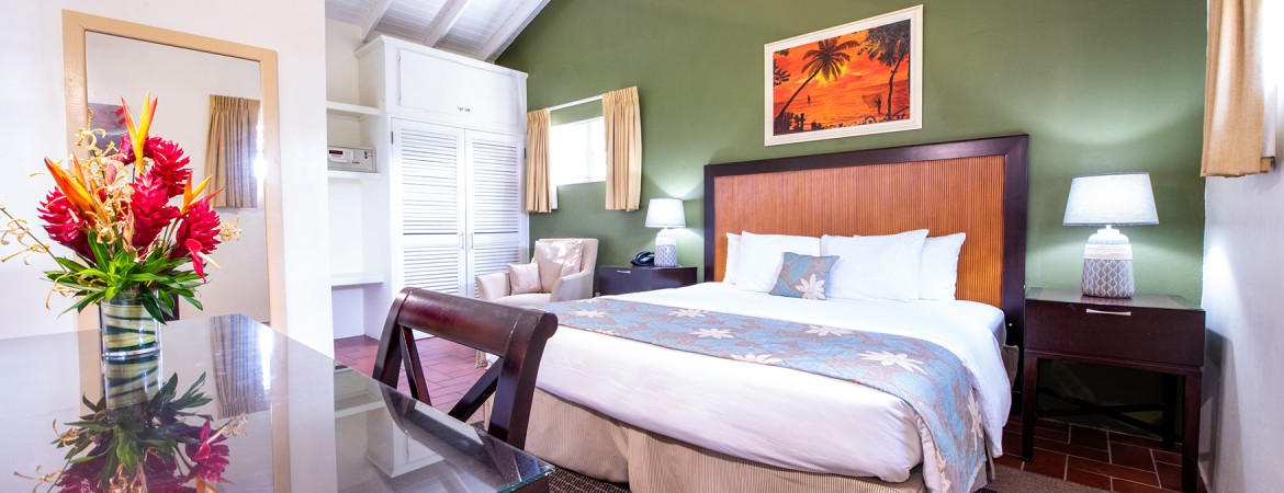 a room with a bed and chairs