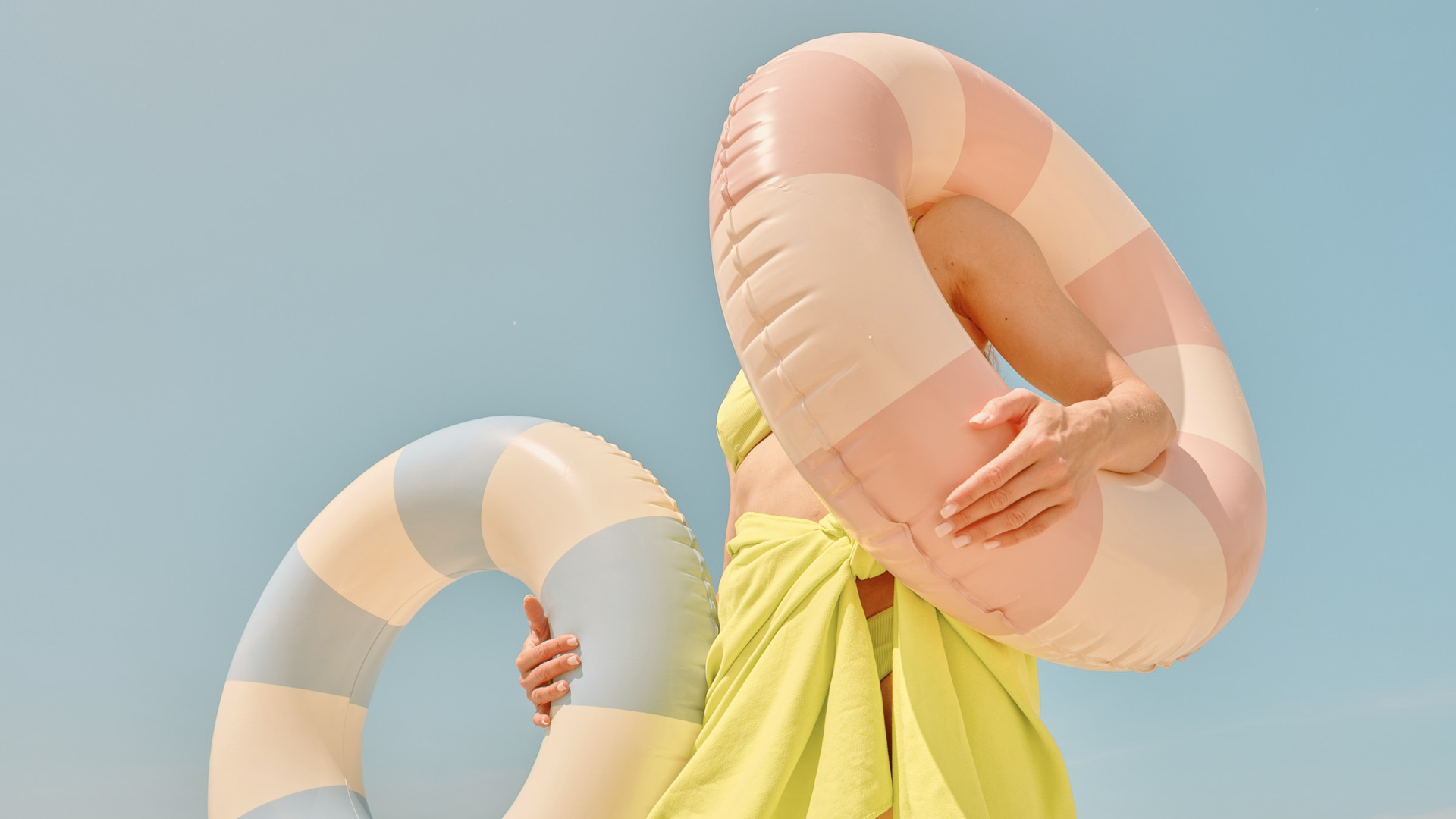 a woman holding a float around her face