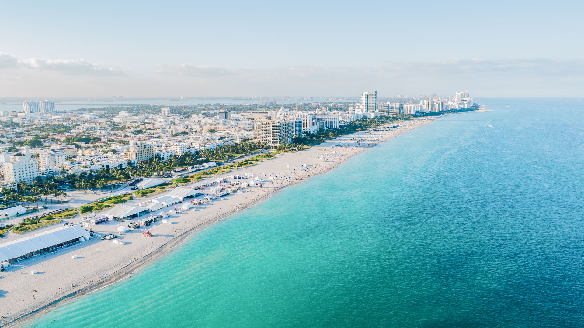a beach with buildings and a body of water