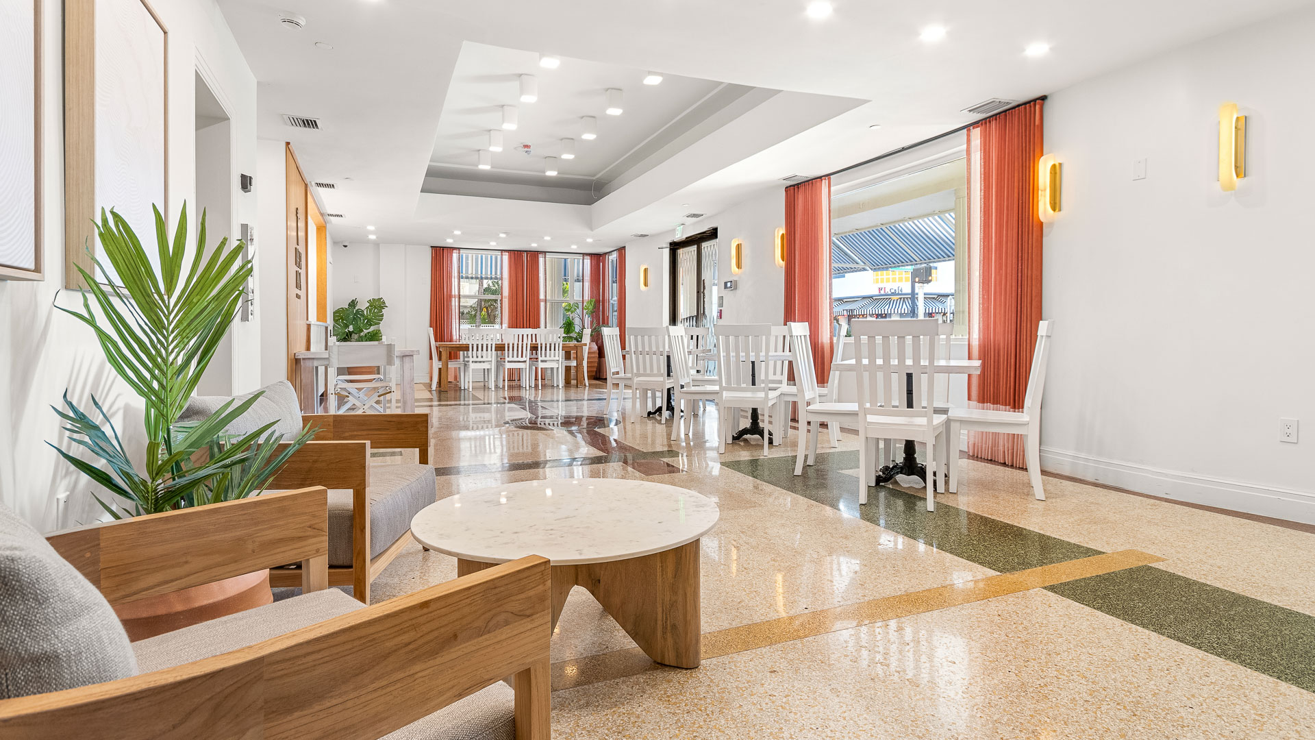 a room with white furniture and tables