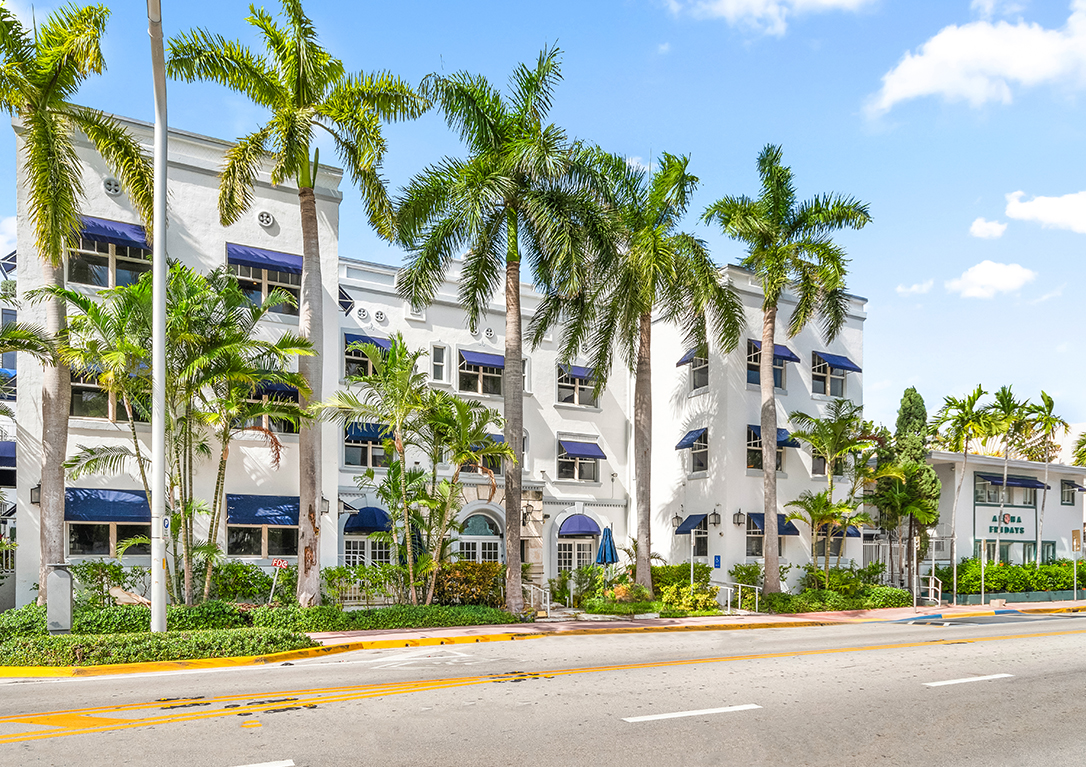a white building with palm trees