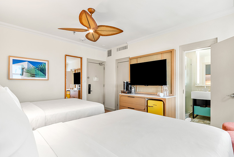 a room with two beds and a television