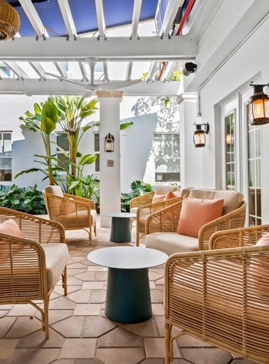 a patio area with chairs and a table