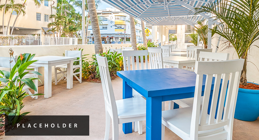 a table and chairs under an umbrella