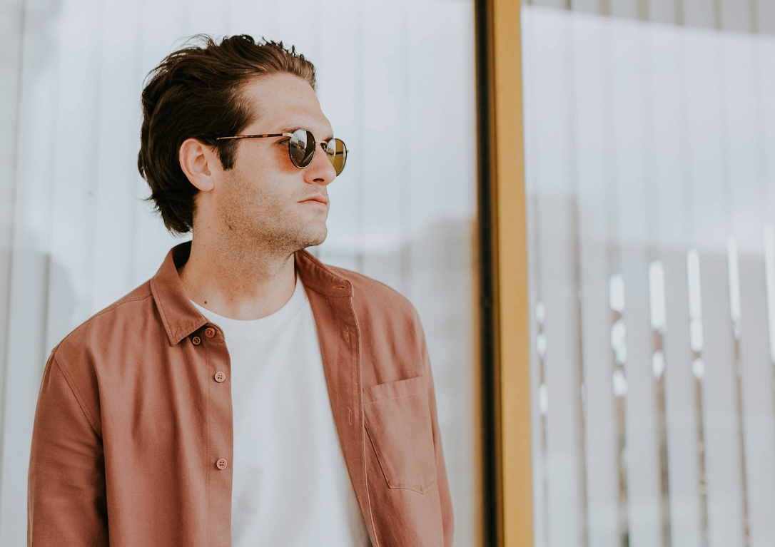 a man wearing sunglasses and a white shirt