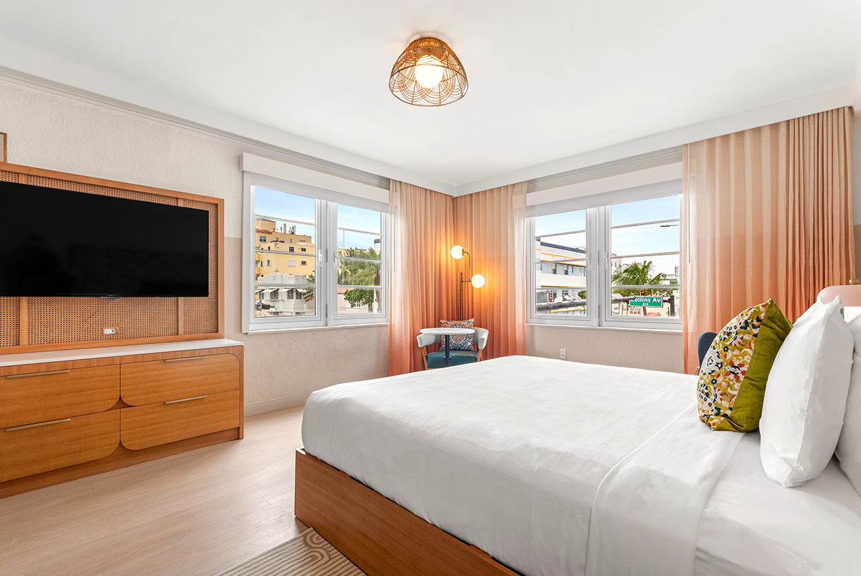 a bedroom with a bed and a television