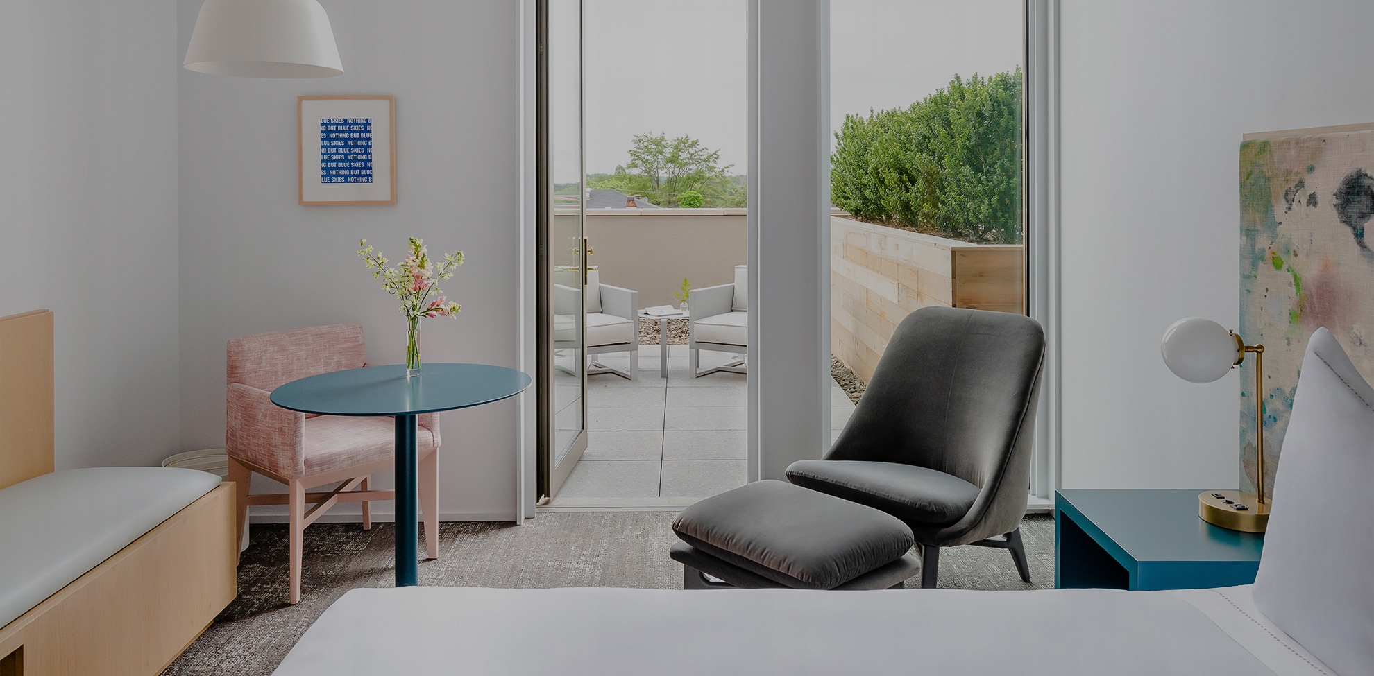 a room with a bed and a table and chairs