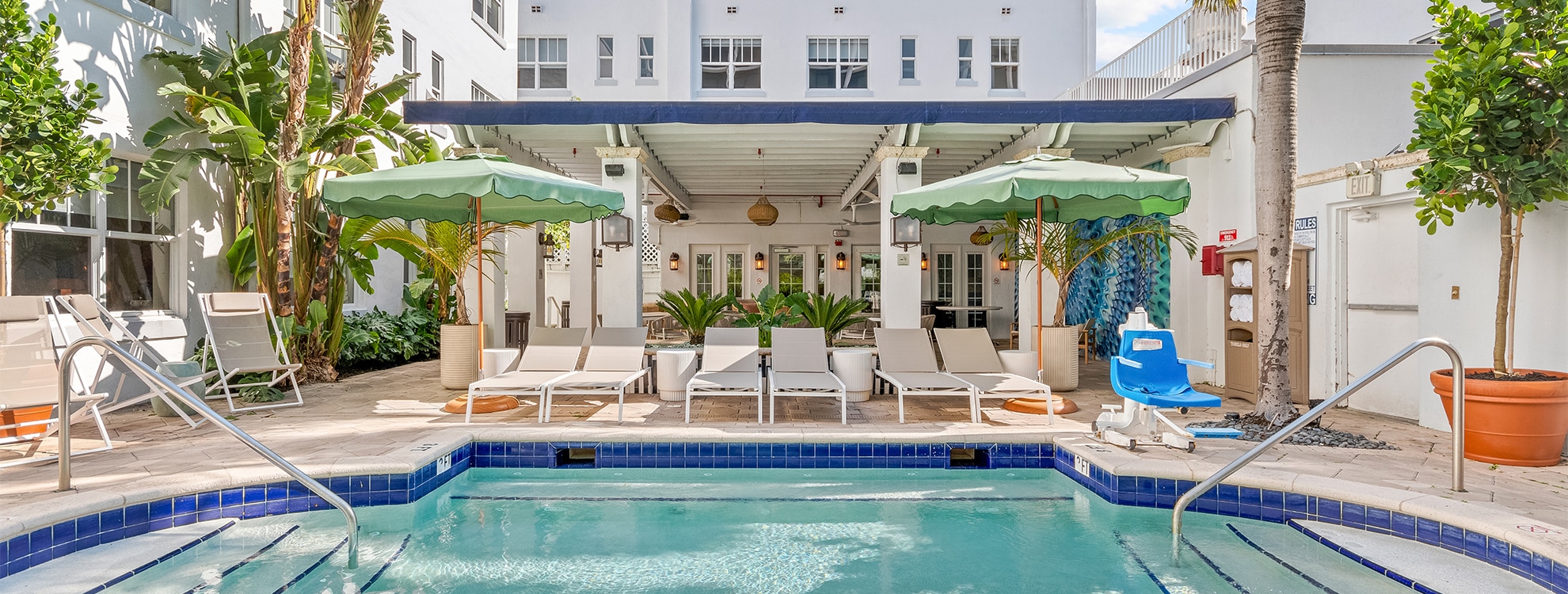 a pool with lounge chairs and umbrellas