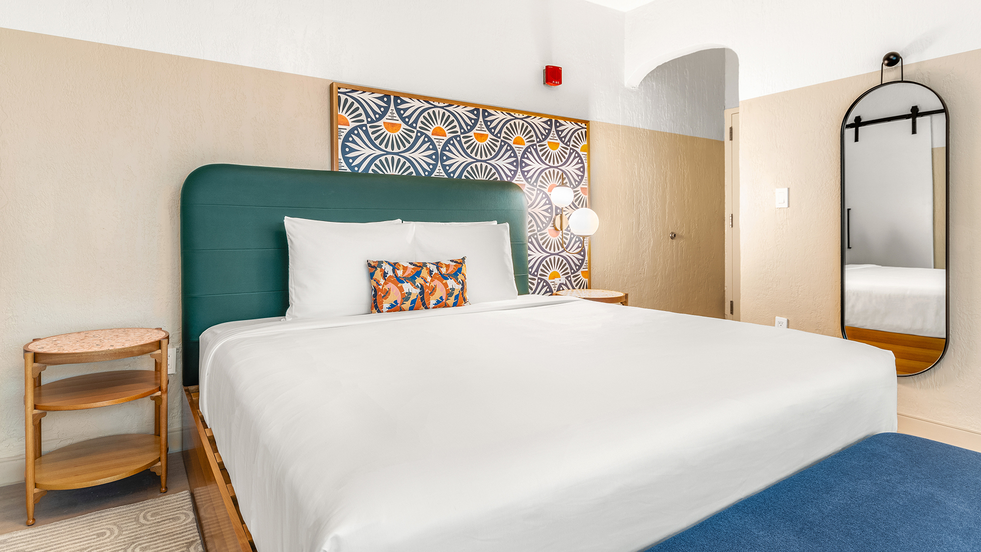 a bed with a blue headboard and white sheets