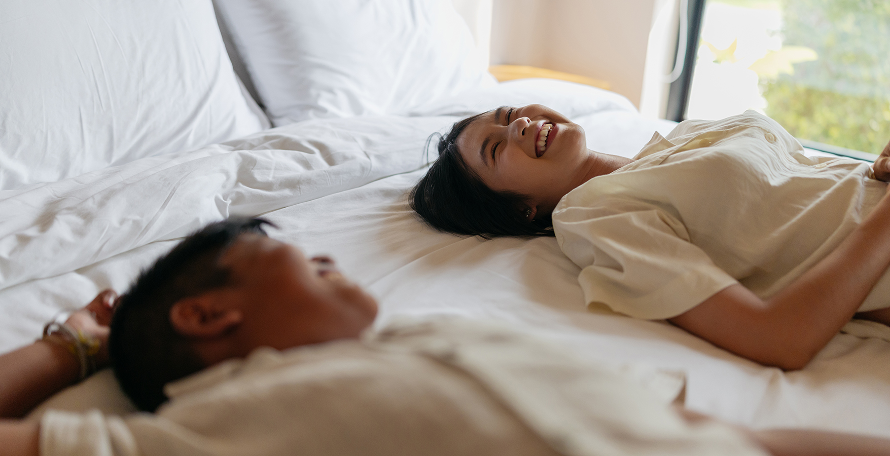 a man and woman lying on a bed