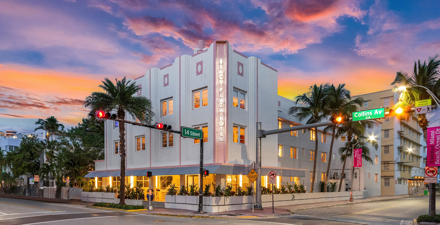 a building with palm trees and a street light