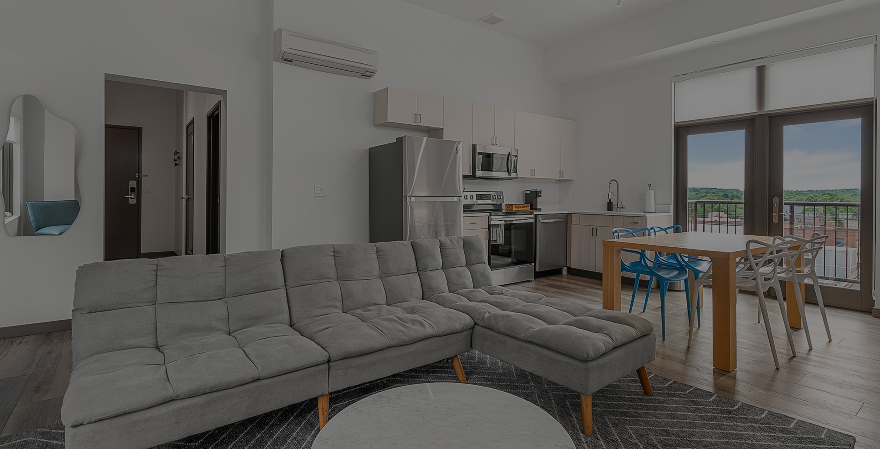 a living room with a couch and kitchen