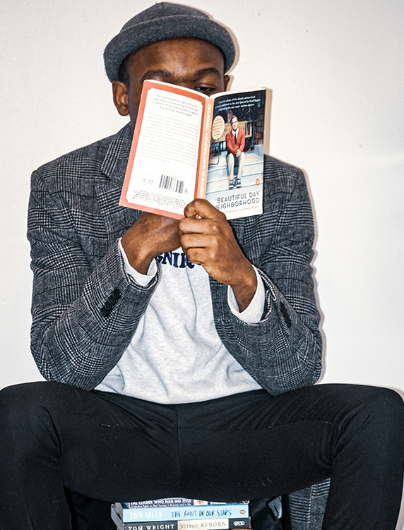 a man sitting on a bench reading a book