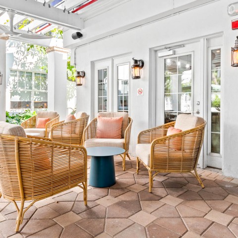 a patio with chairs and a table