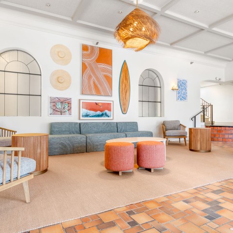 a room with a couch and chairs