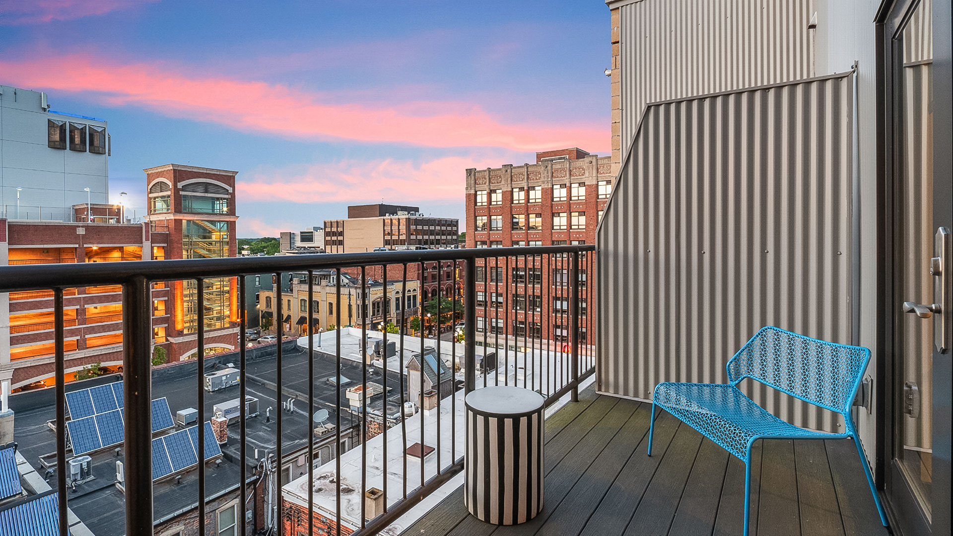 a balcony with a blue chair and a table