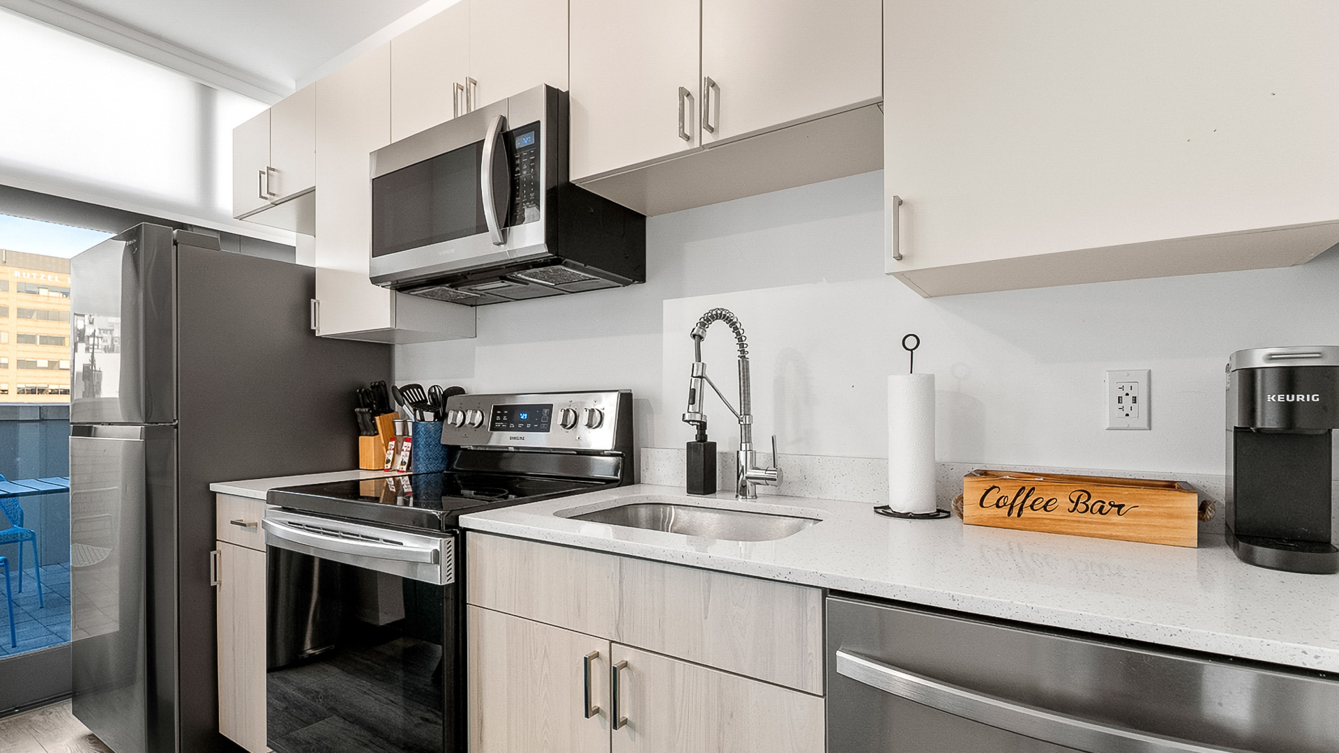a kitchen with white cabinets and a black stove