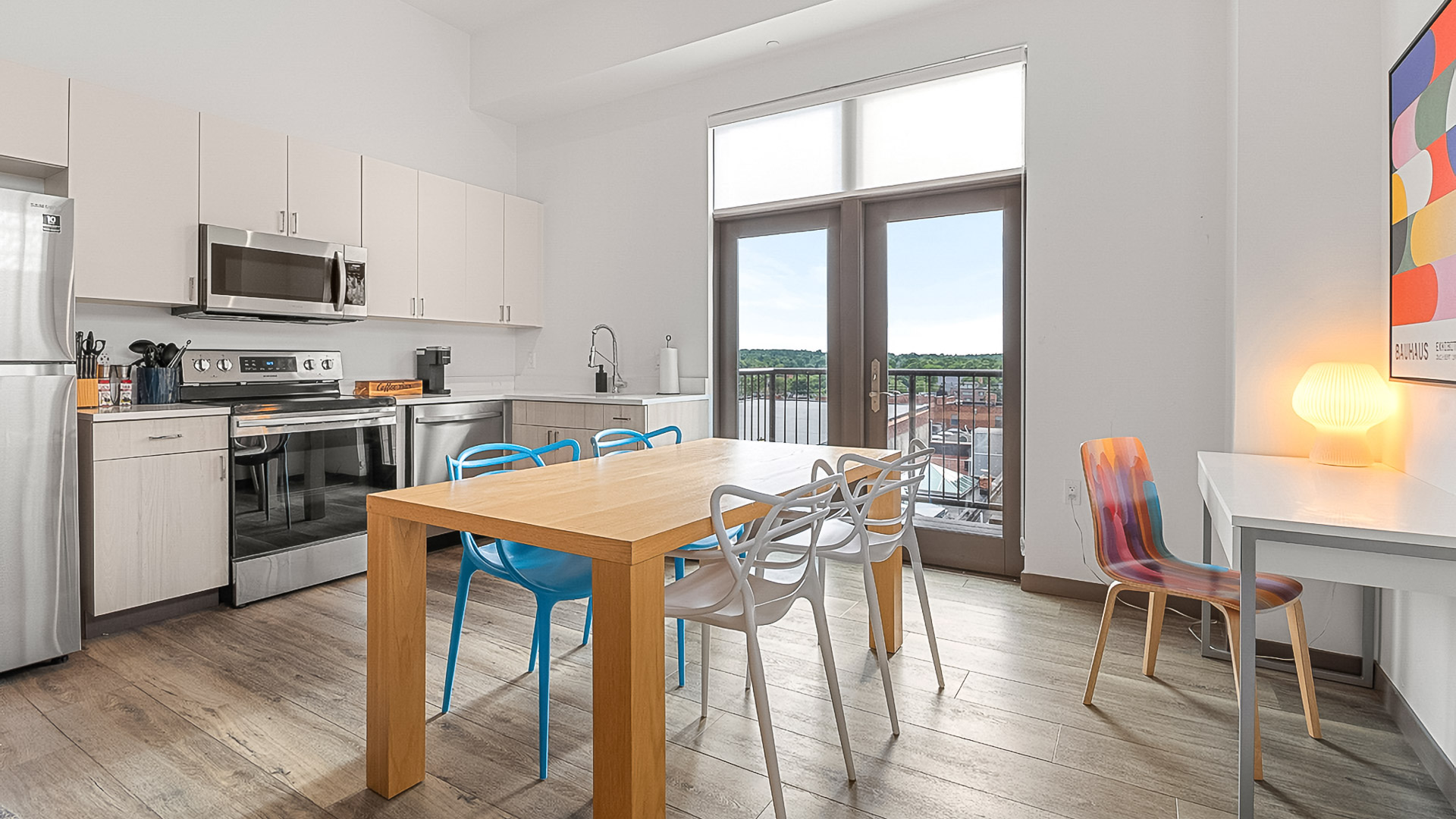 a dining table and chairs in a room with a view of a city