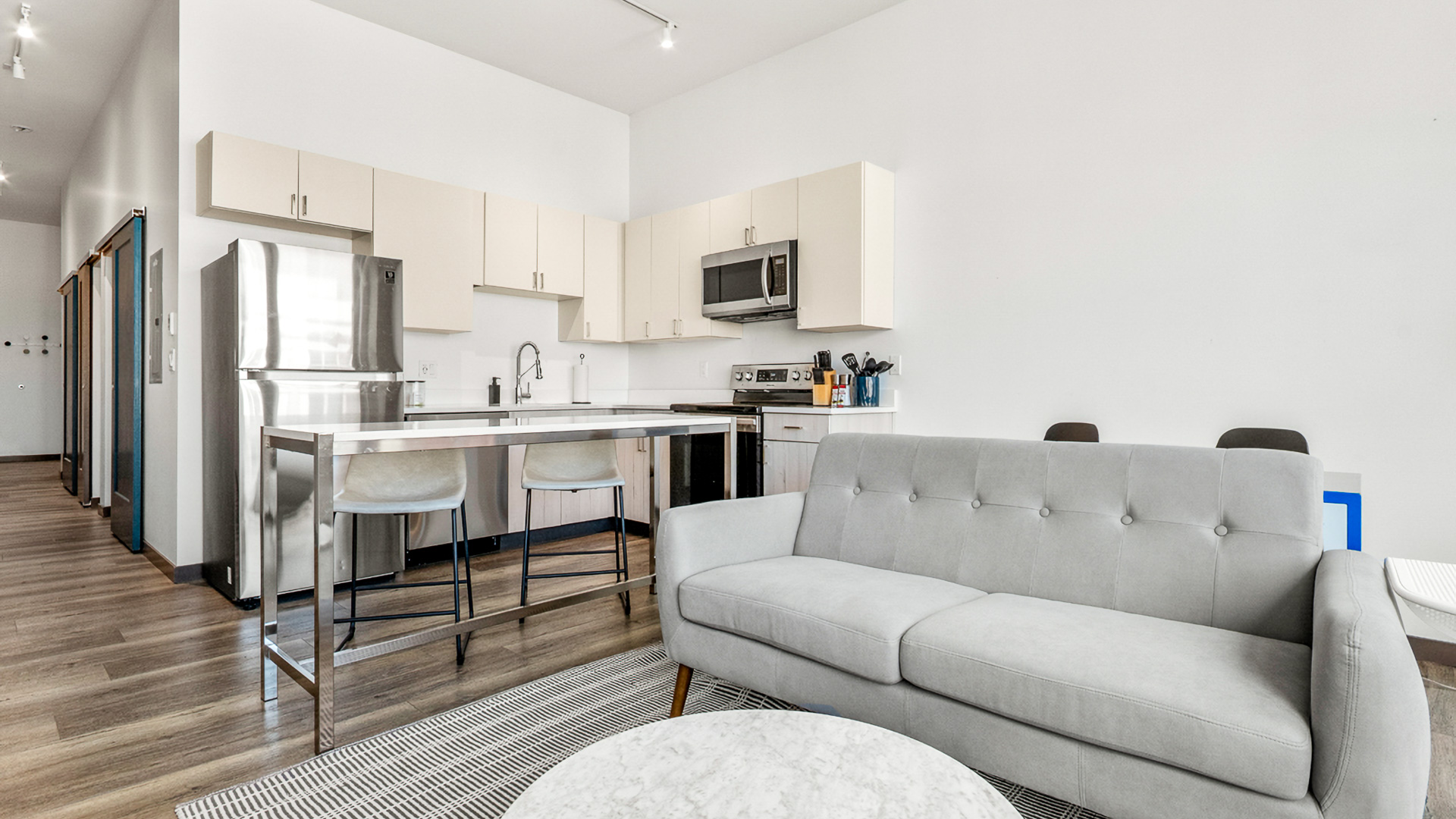 a living room with a couch and kitchen