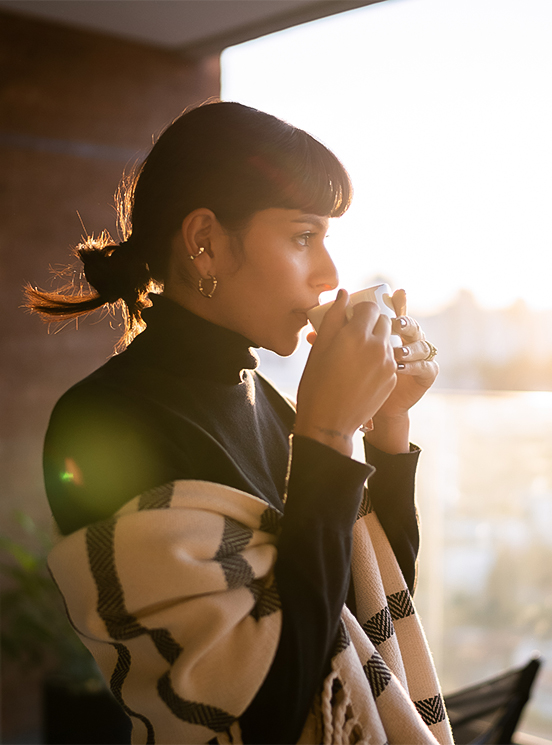a woman drinking from a cup