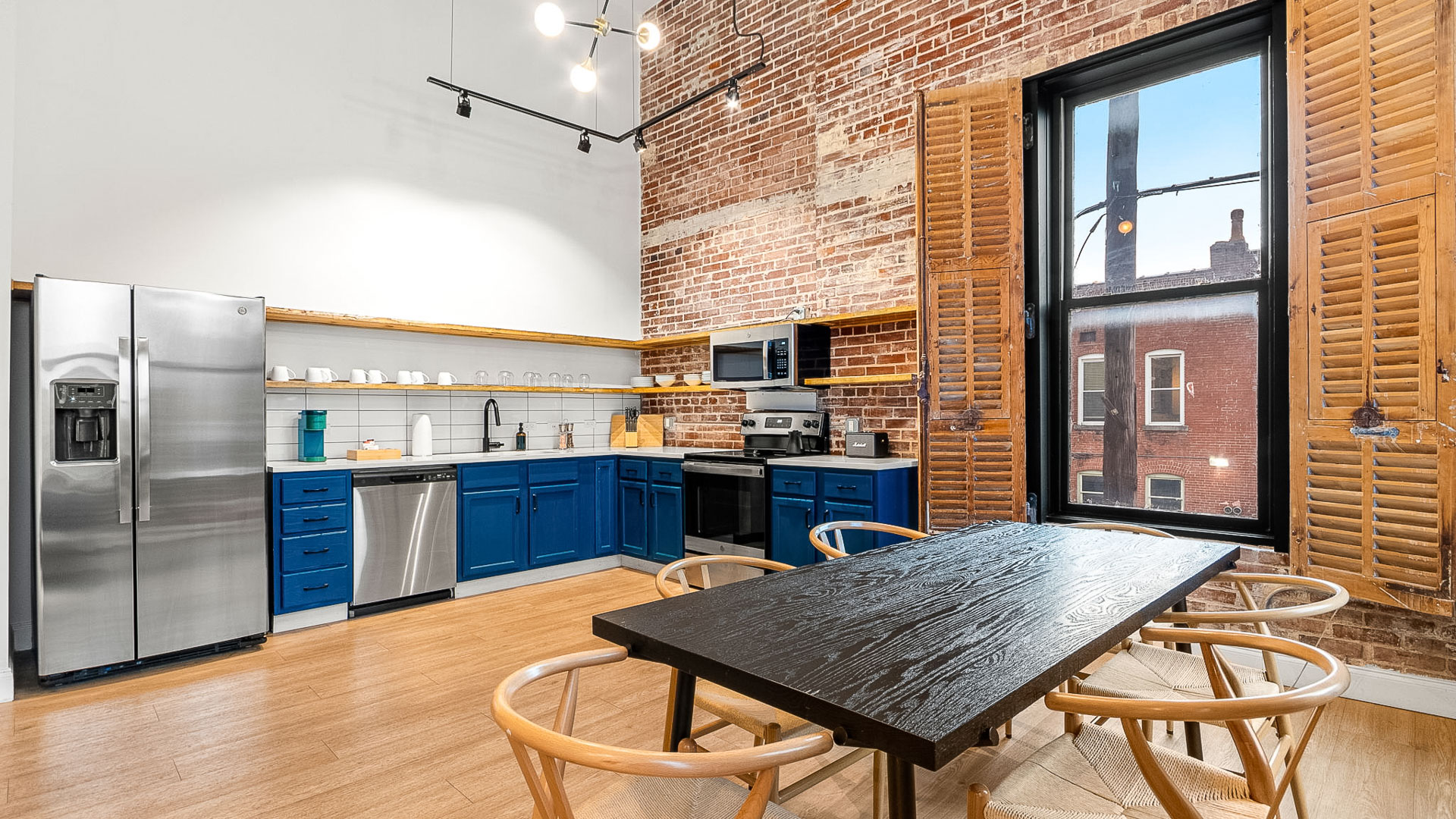 a kitchen with blue cabinets and a table