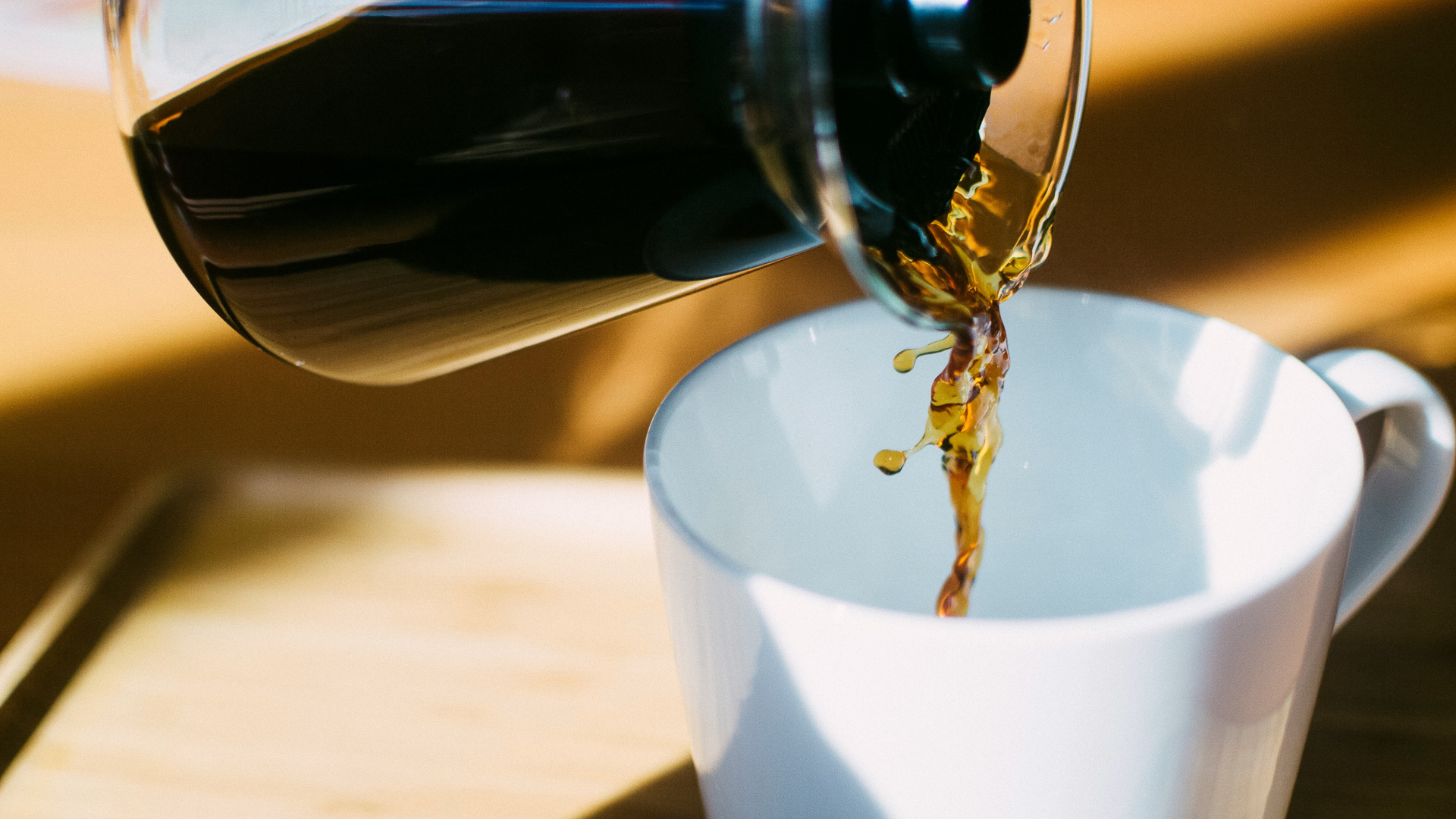 a coffee being poured into a cup
