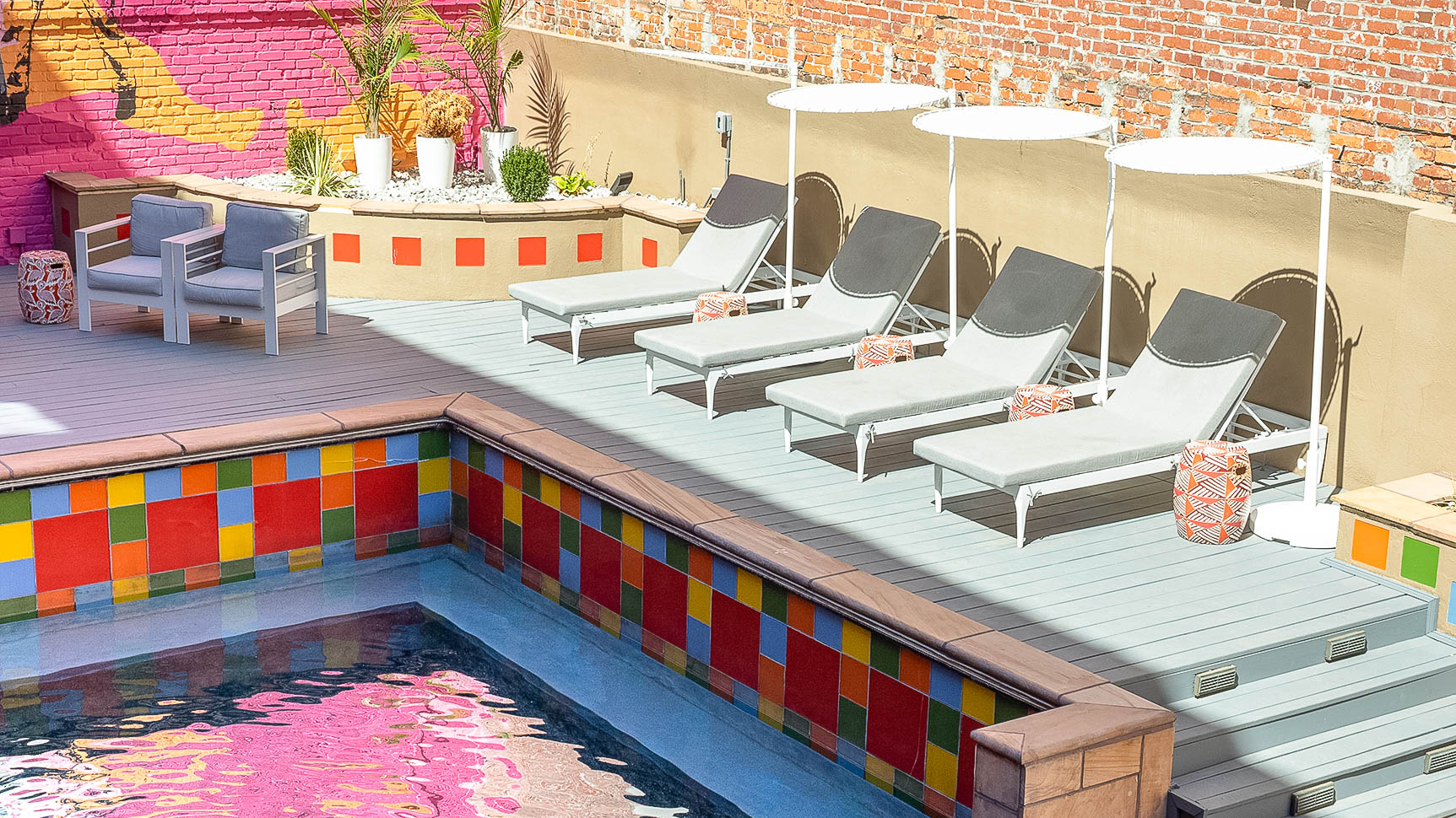 a pool with chairs and umbrellas