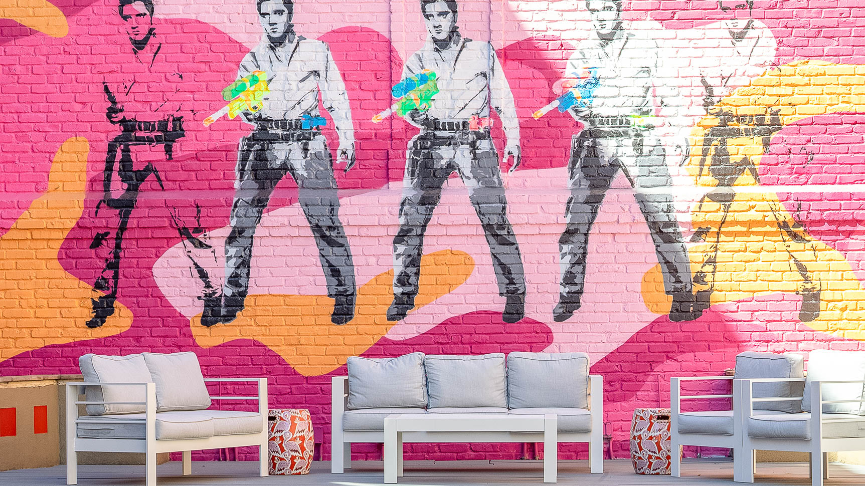 a wall with a painting of a man on it