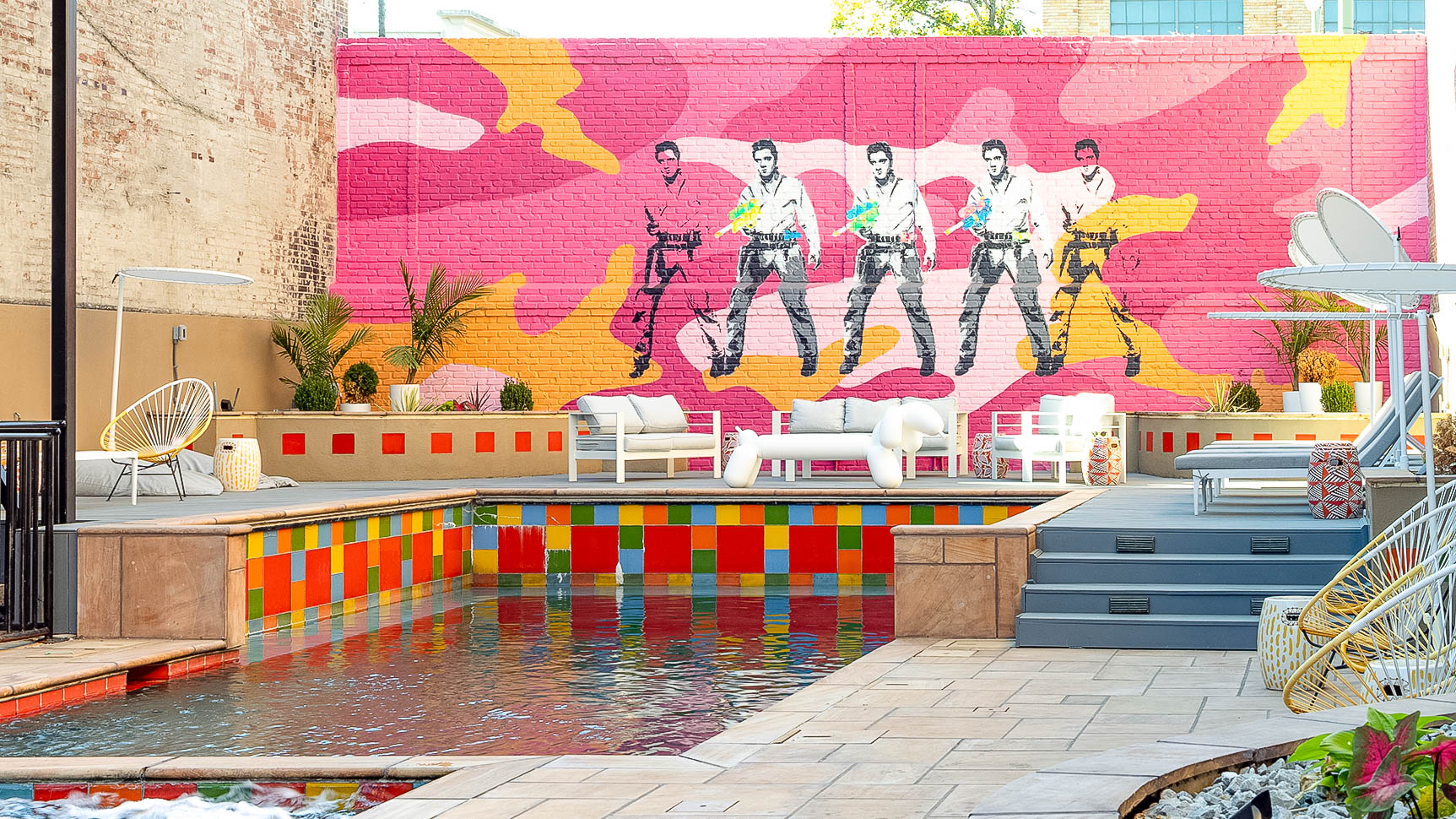 a pool with a painting on the wall