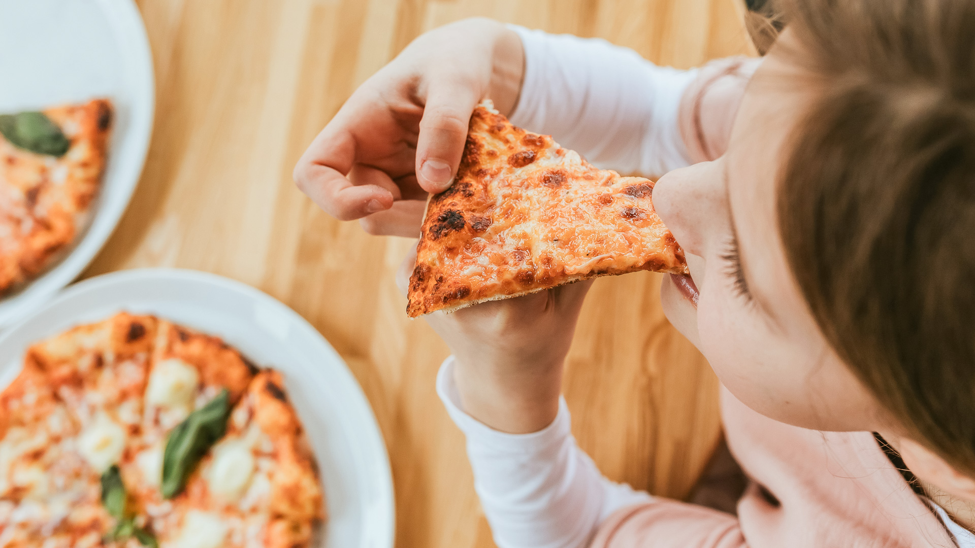 a person eating a slice of pizza