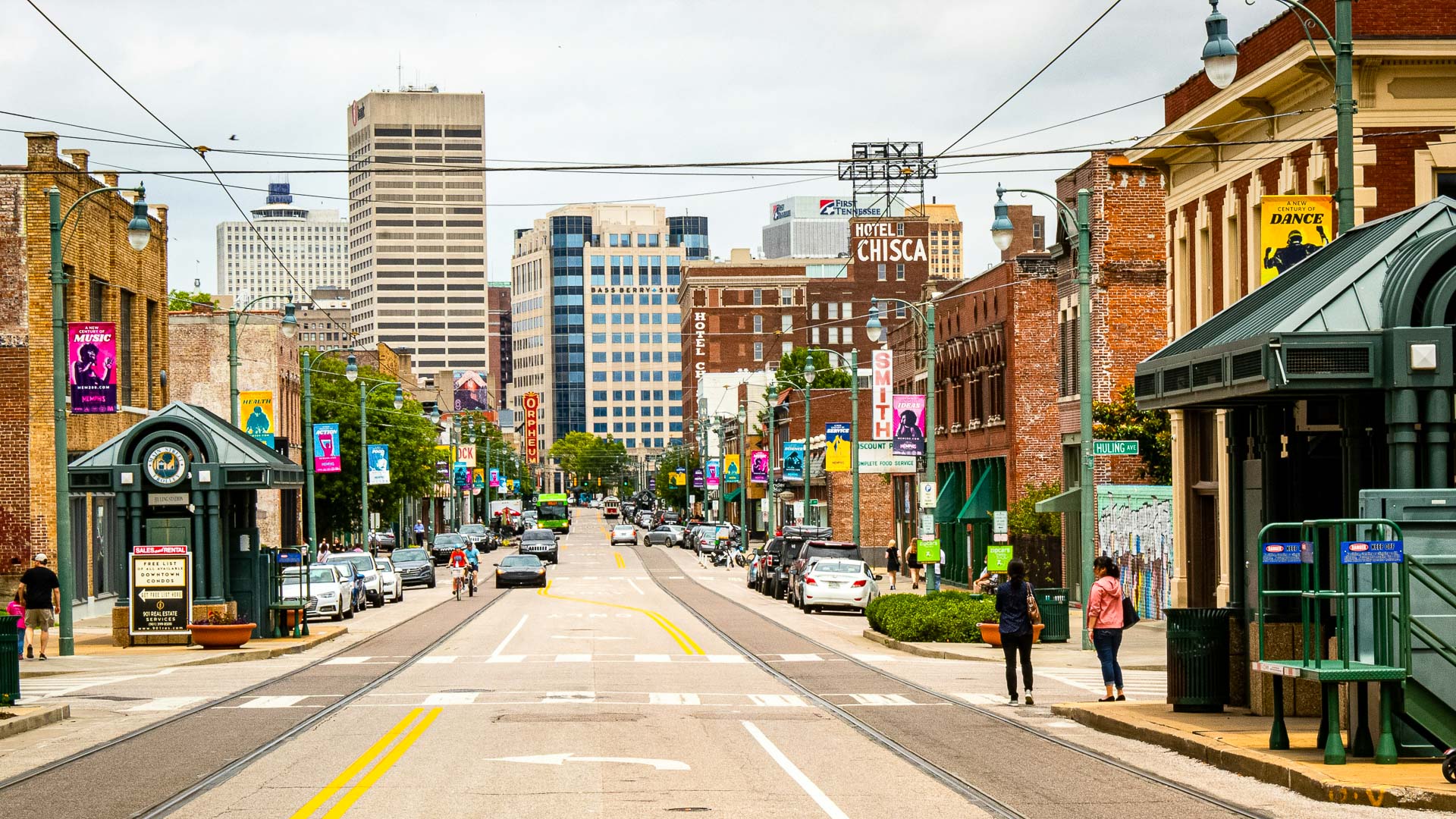 a street with cars and buildings in the background