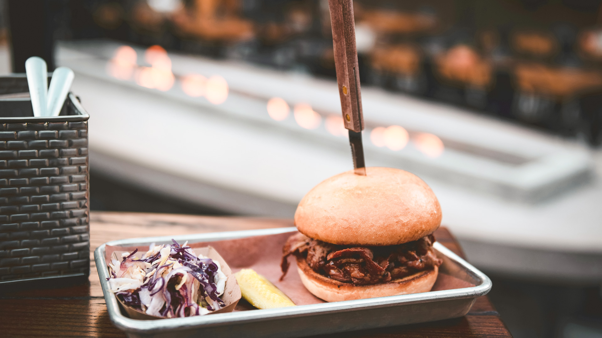 a burger with a knife on top of it
